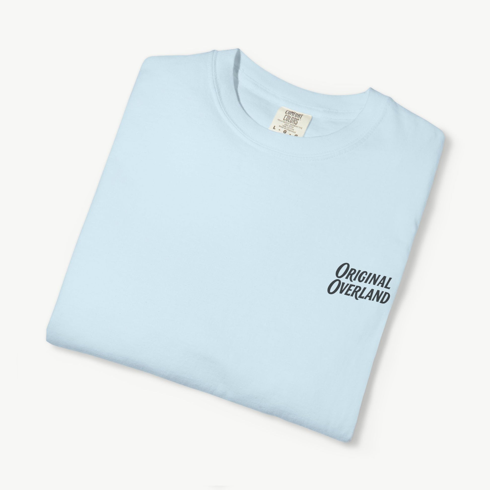 Folded chambray FJ60 ‘Still Not a Jeep’ shirt with front logo visible