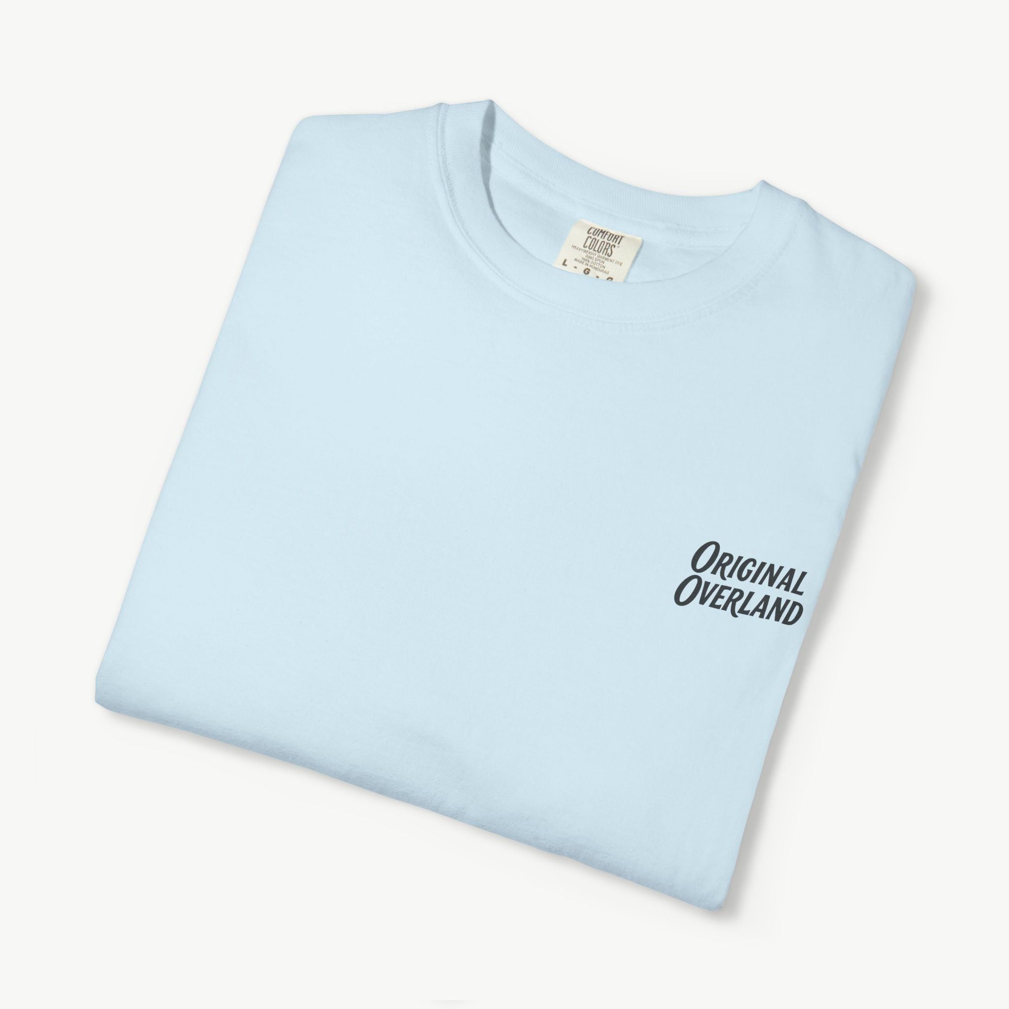 Folded chambray FJ60 ‘Still Not a Jeep’ shirt with front logo visible