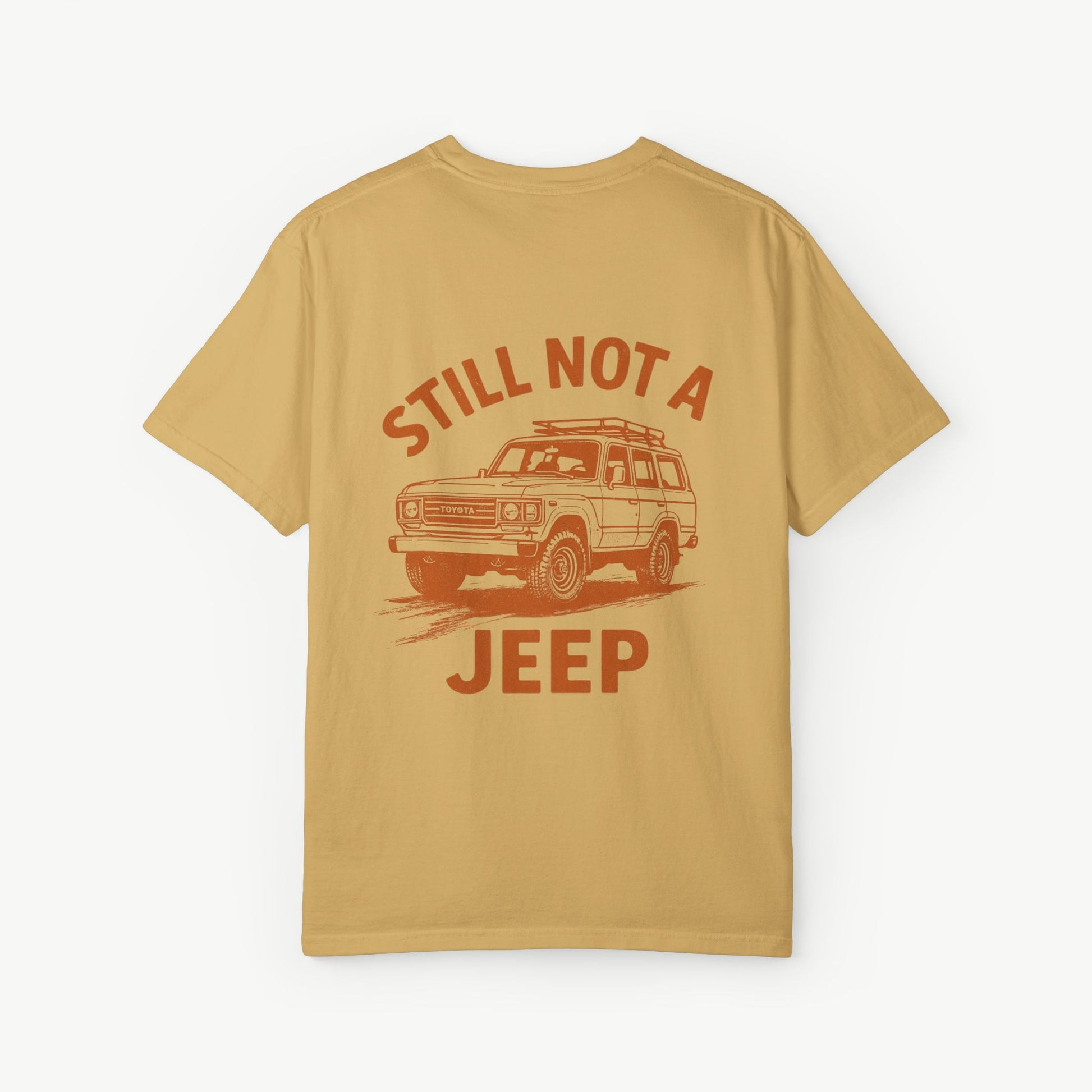 Mustard FJ60 ‘Still Not a Jeep’ shirt featuring vintage Toyota Land Cruiser desert graphic.