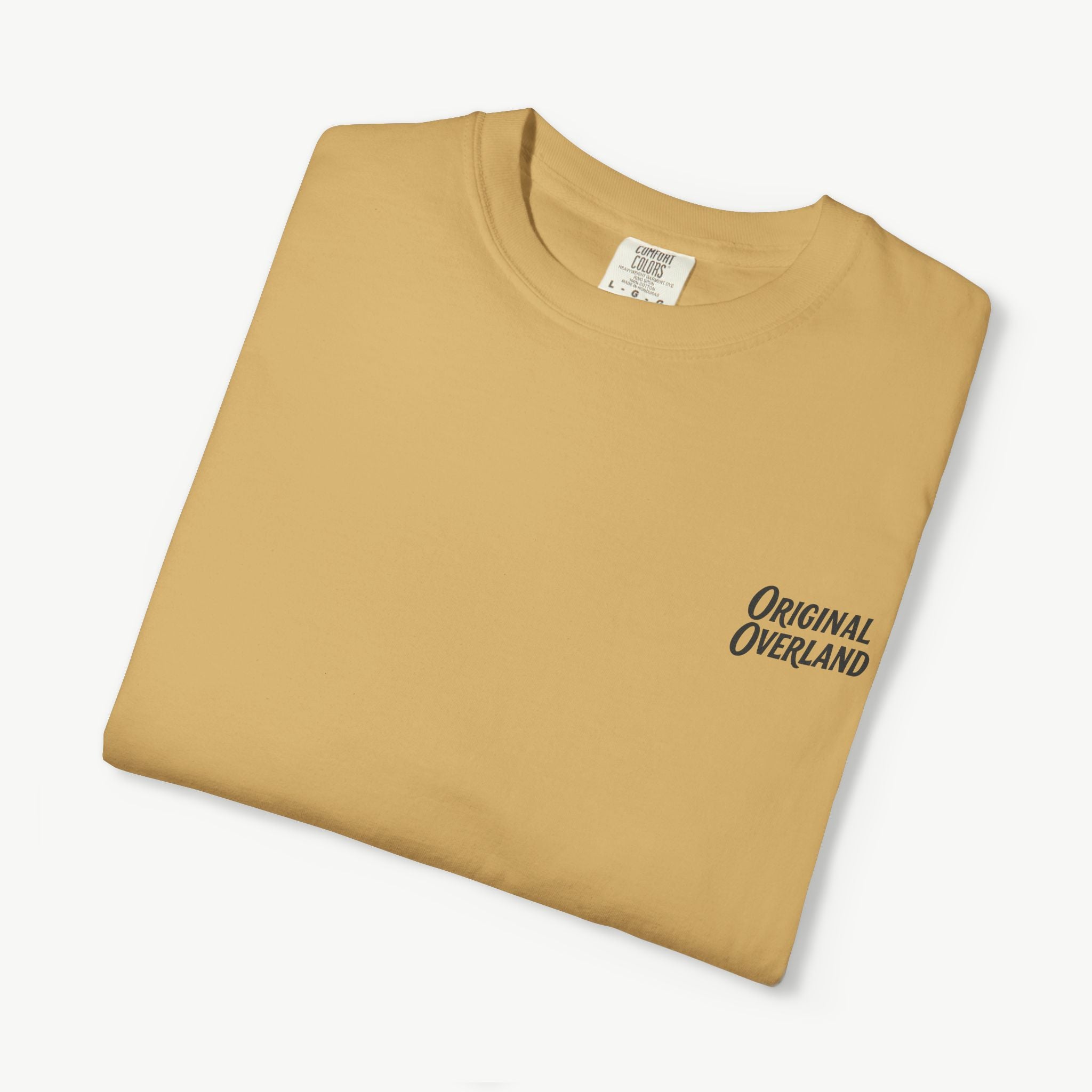 Folded mustard FJ60 ‘Still Not a Jeep’ shirt with front logo visible.